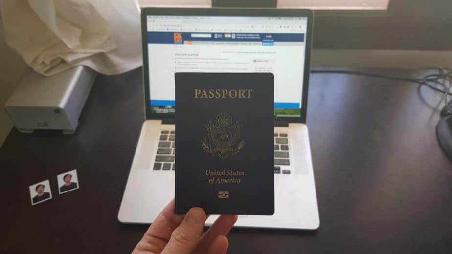 US passport with computer and passport photos