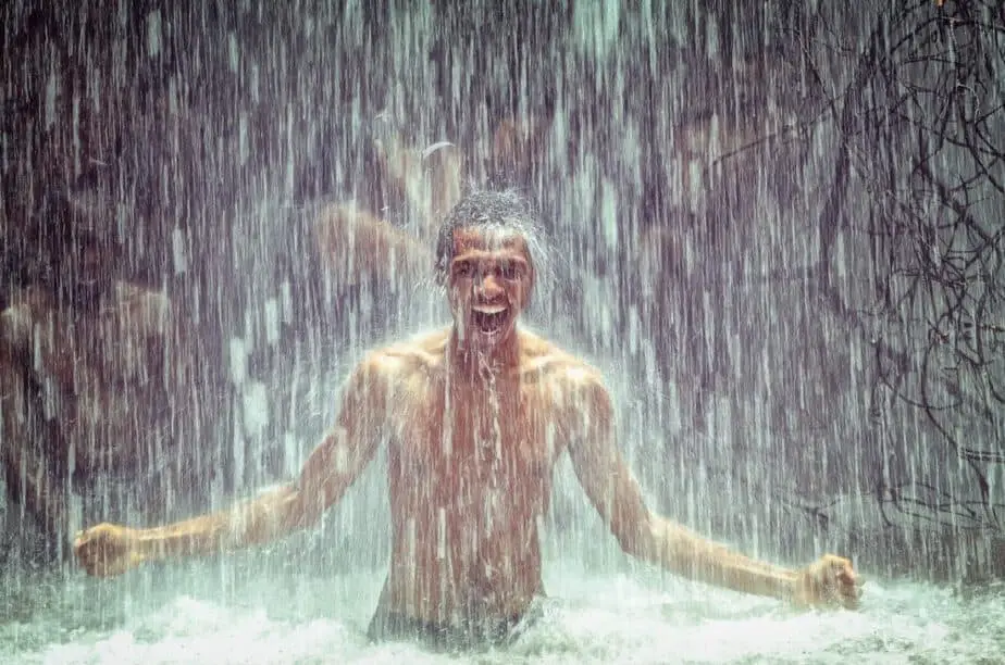 man under waterfall