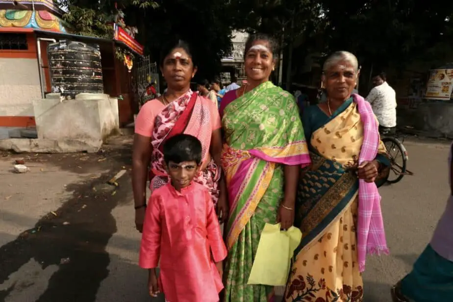 locals in india in front of a temple in colorful clothing
