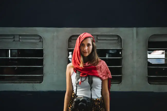 Western female traveler standing at a railway station in Varanasi