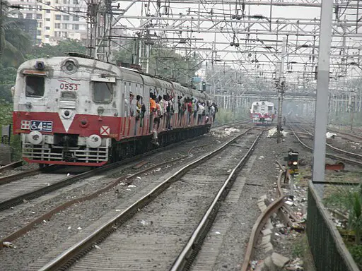mumbai local train and tracks with power lines