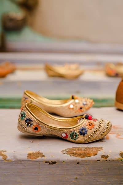 View of traditional juttis on the wall of an Indian street vendor's stall