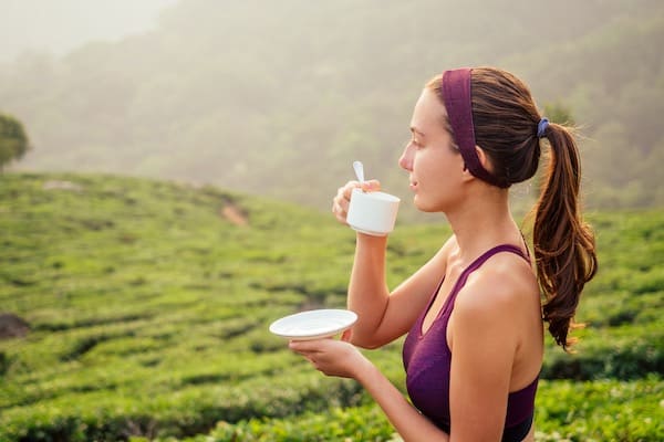 woman drinking tea cup factory in India Munnar.