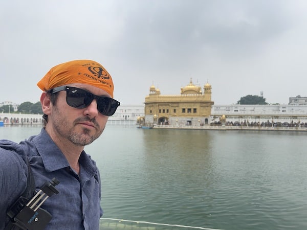 golden temple ben jenks standing front amritsar good solo trips india and workations